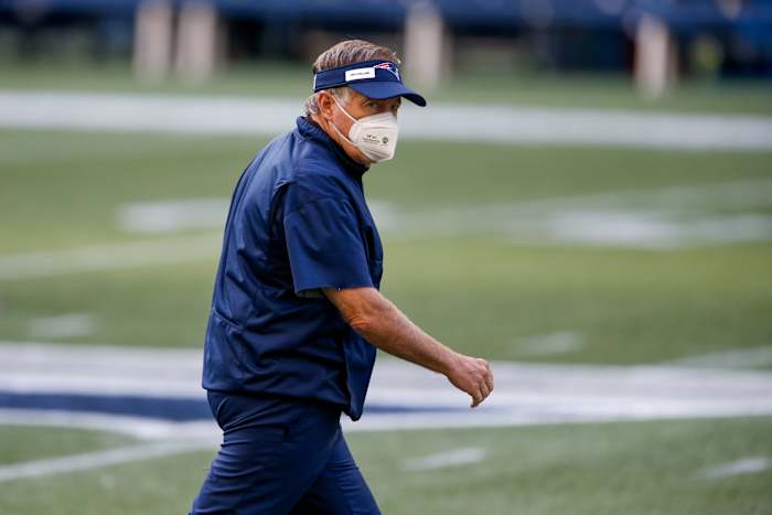 Patriots head coach Bill Belichick stares down CenturyLink Field wearing an N-95 face mask.